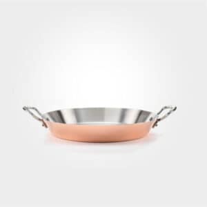 copper paella dish on white background