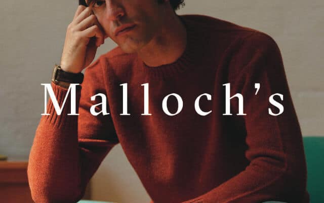 malloch's brand lock up man in orange jumper