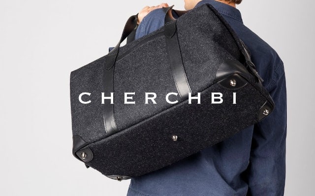 cherchbi brand lock up with man carrying a cherchbi black holdall