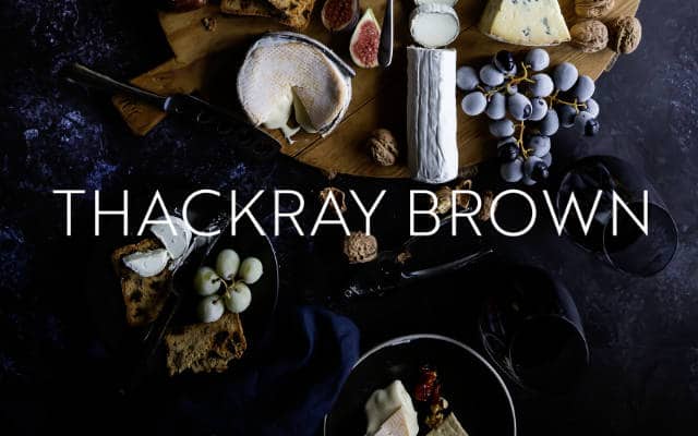 thackray brown white logo on layout of food on purple table