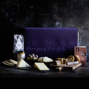 luxury british hamper with artisan food and drink in front of hamper