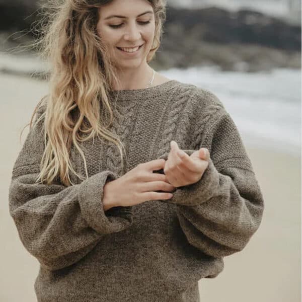 light brown guernsey jumper with women on beach made from cornish yarn
