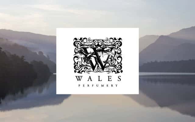 wales perfumery brand lock up with white logo on background of snowdonia